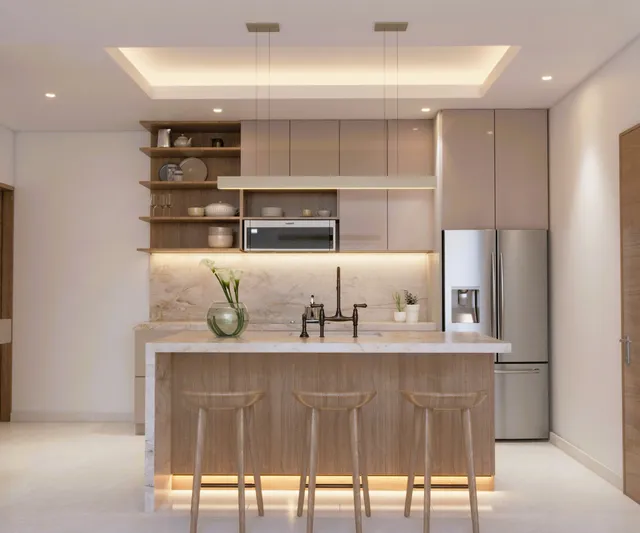 Modern kitchen with island and bar seating in a Vista Los Sueños condominium