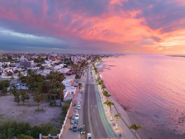 La Paz malecón with a pink sunset over the ocean