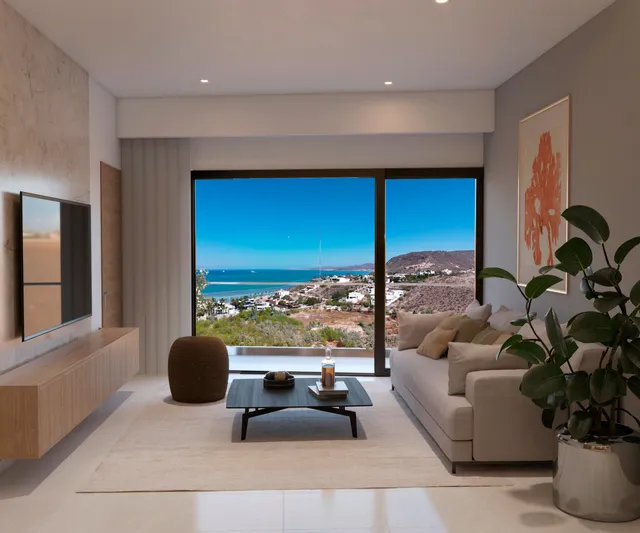 Living room with panoramic ocean view in a Vista Los Sueños condominium