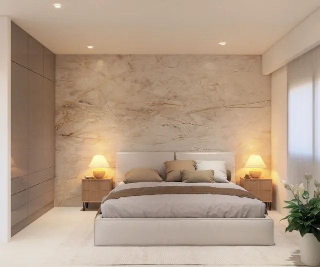 Master bedroom with marble accent wall in a Vista Los Sueños condominium