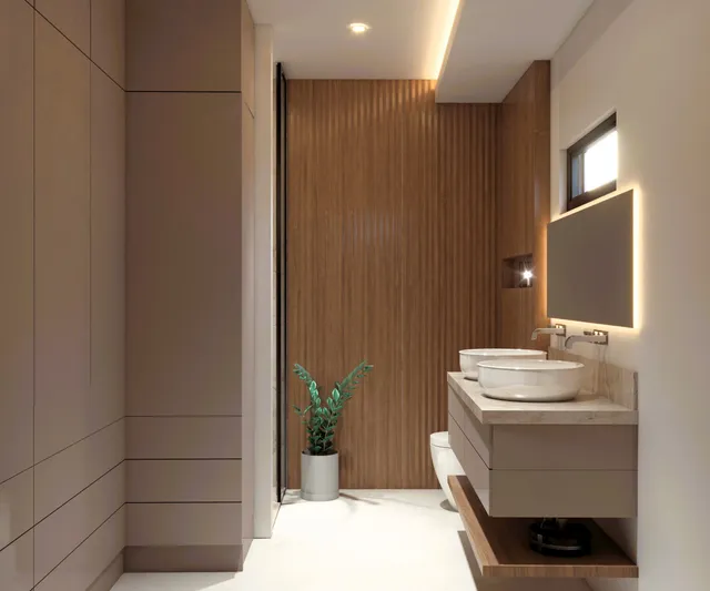 Second bathroom with wood slat walls and double sinks in a Vista Los Sueños condominium
