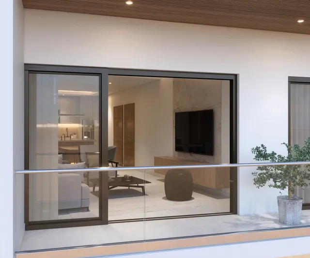Terrace with glass railing and view into the living room at Vista Los Sueños